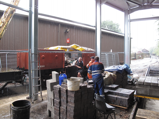 bricks being unloaded from a wagon